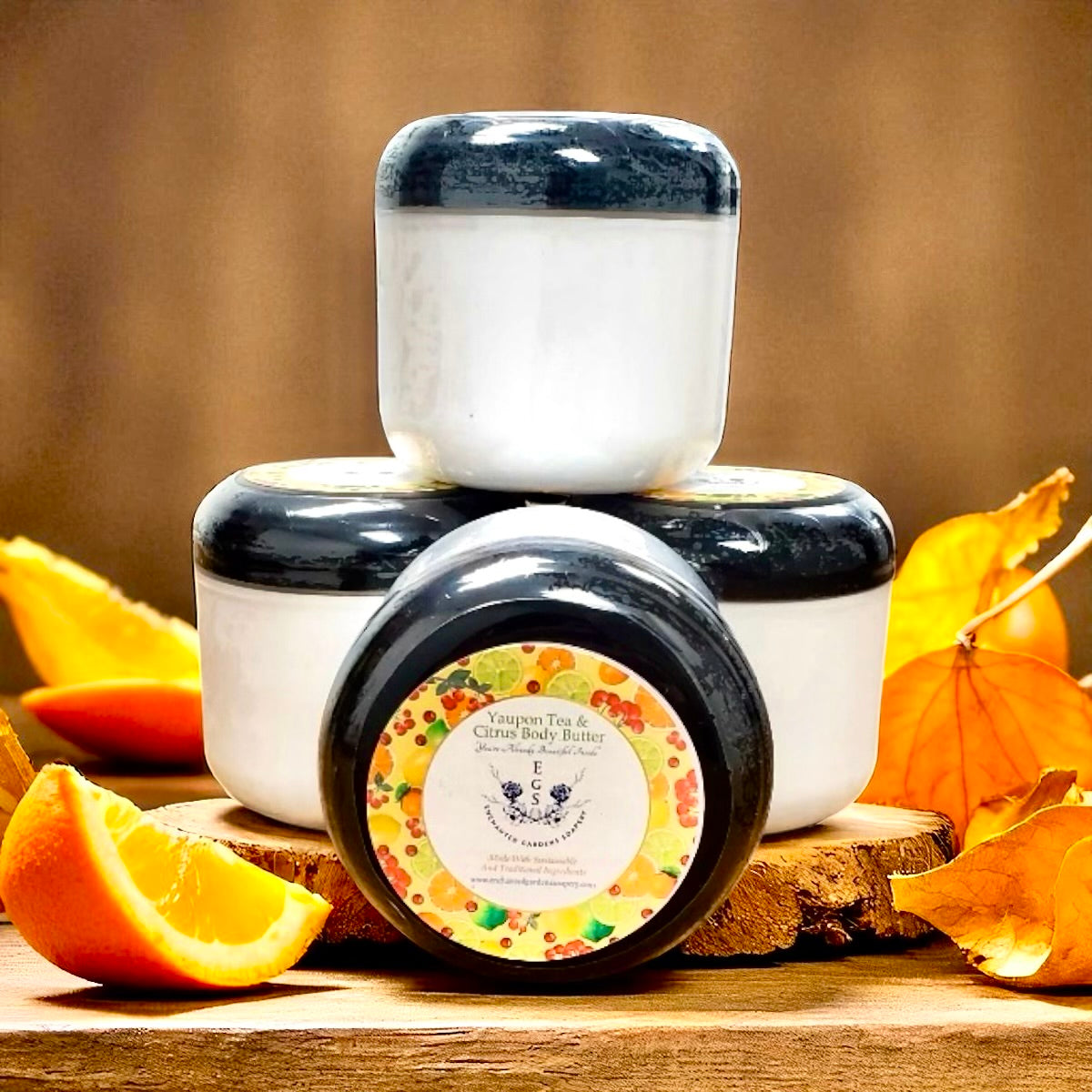 Jar of body butter with a decorative label on a wooden surface with oranges and leaves.