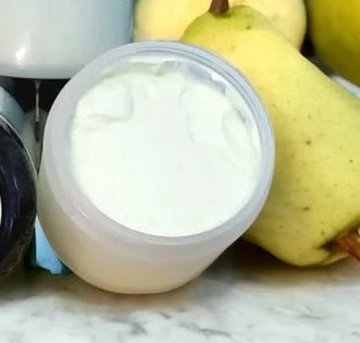 A photo of an open jar of Enchanted Gardens Soapery Handmade body lotion.