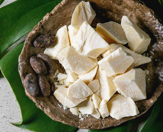 Photo of shaved cocoa butter in a bowl with garnishes.
